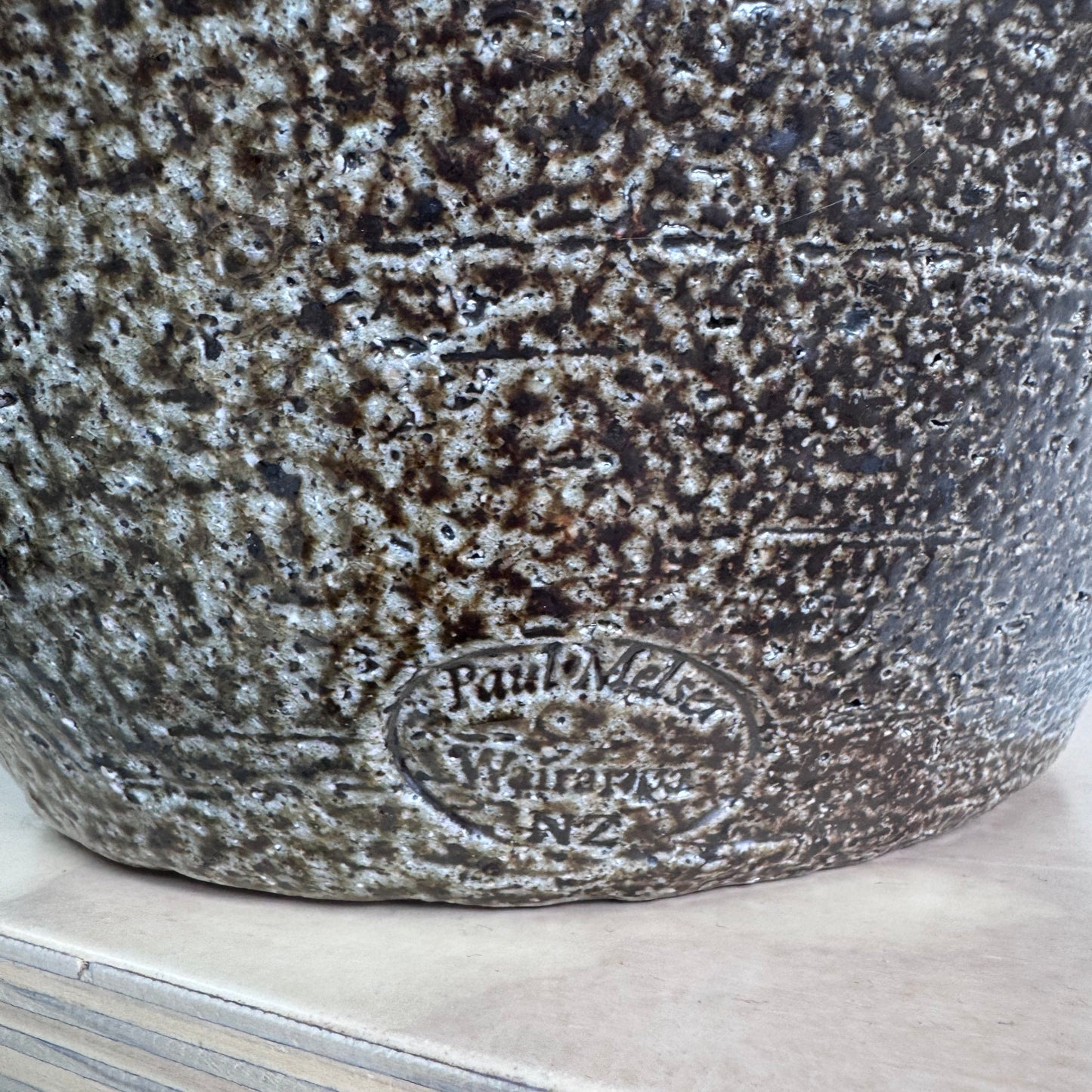 Mark on textured ceramic pot reading “Paul Melser, Wairarapa, NZ”
