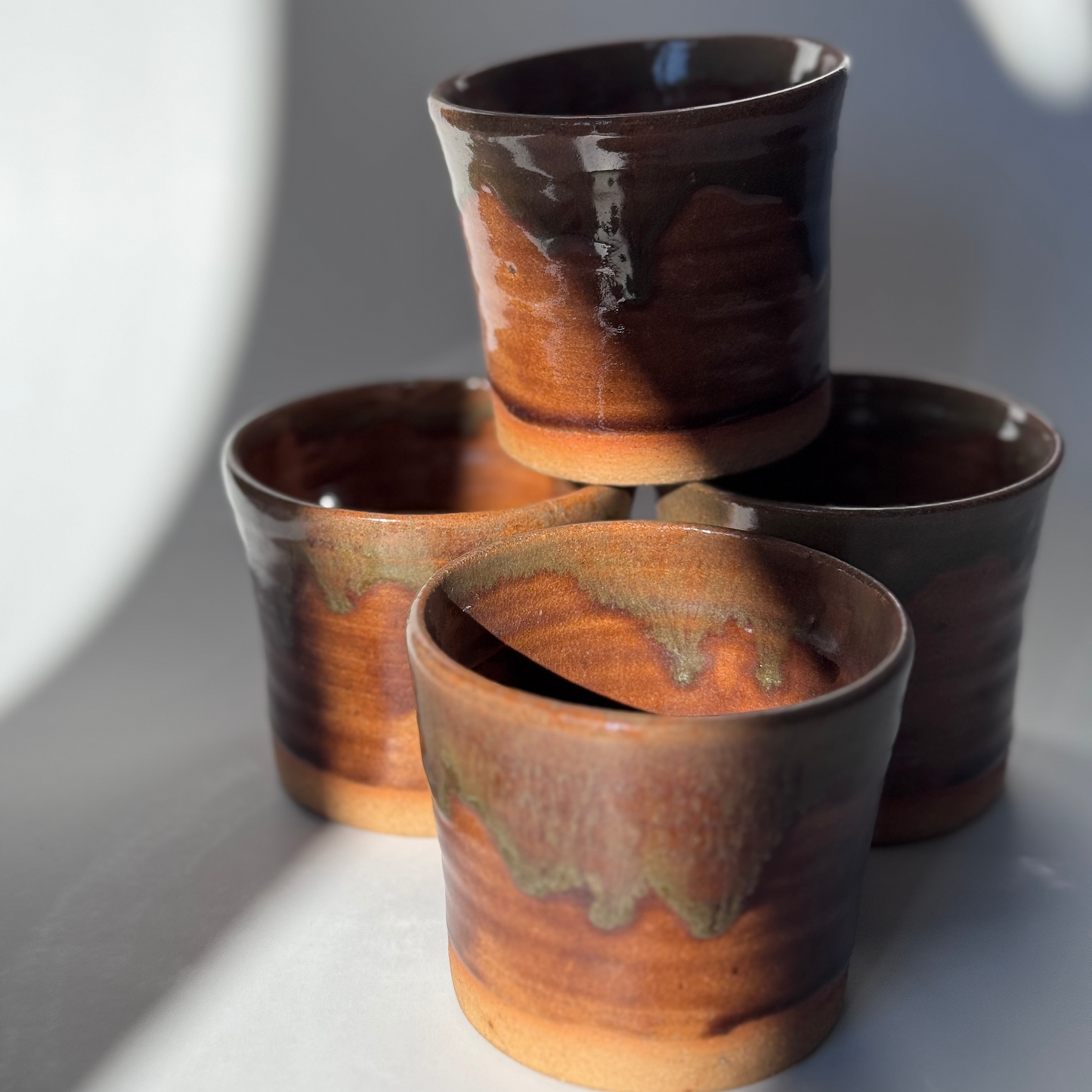 Handmade ceramic tumbler with brown glaze.