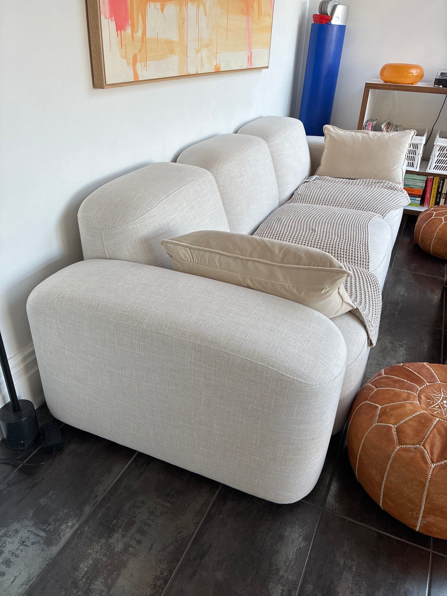 Light gray sofa with decorative pillows in a living room setting.