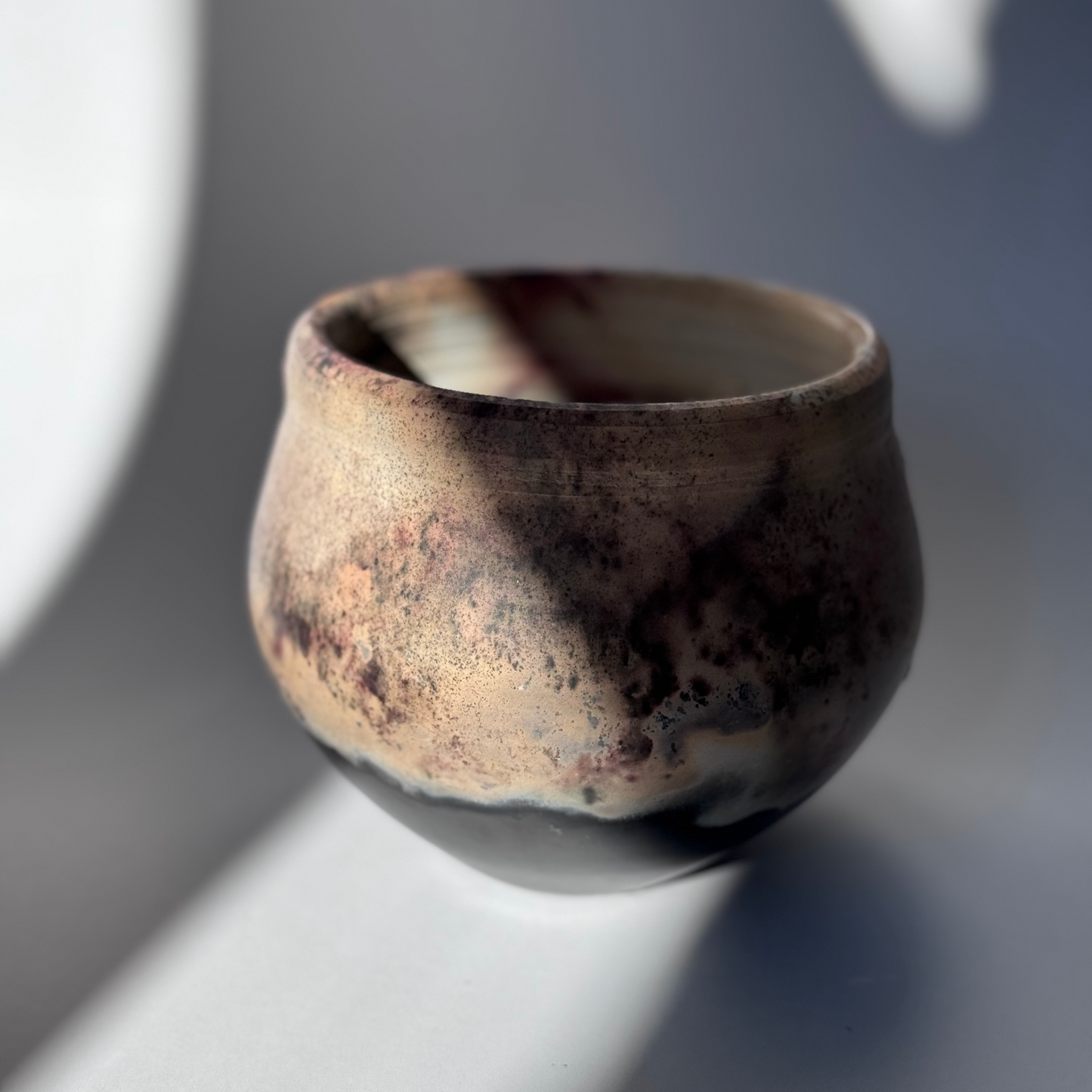 Ceramic cup with a textured surface on a light background