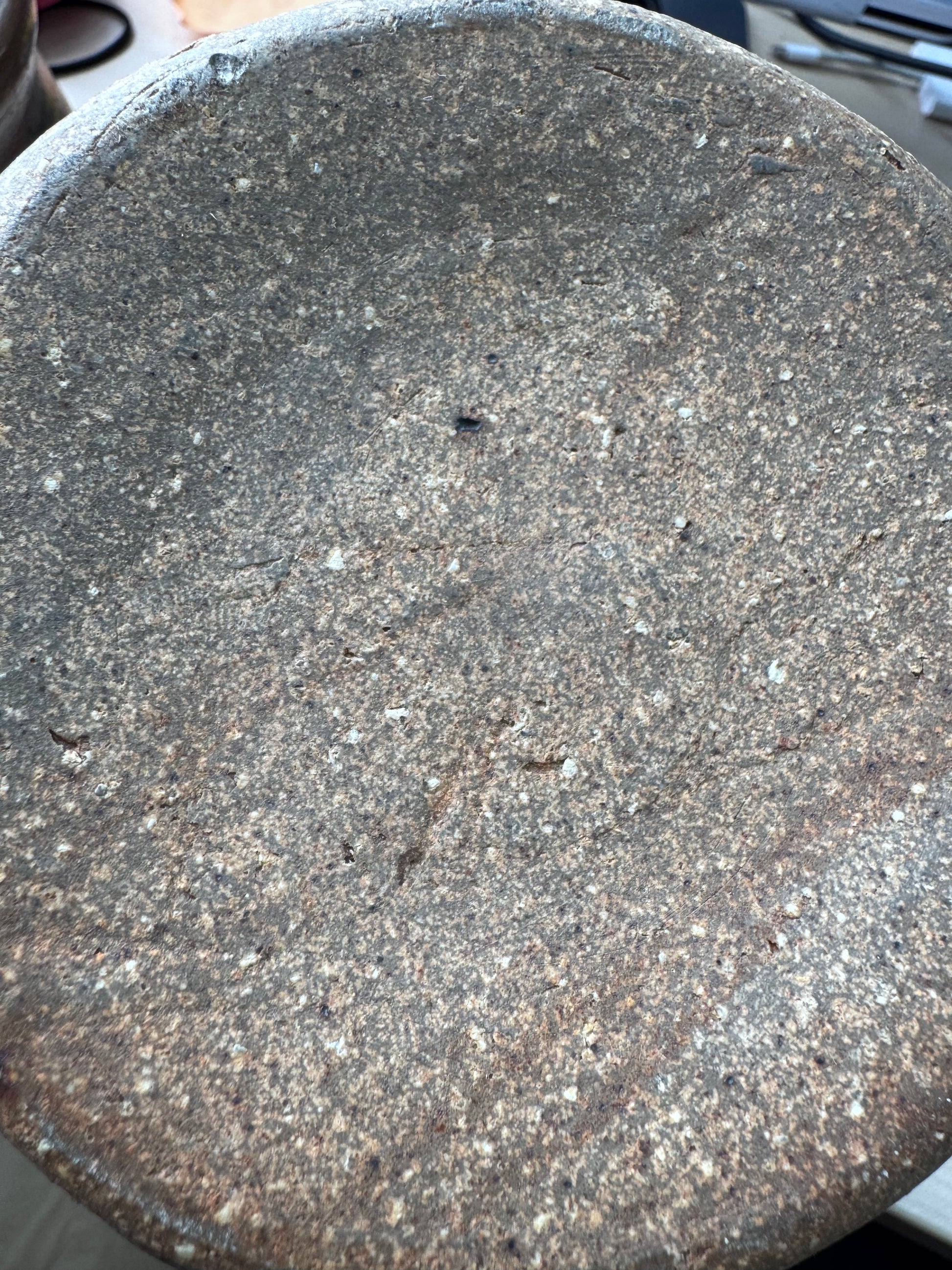 Base of handcrafted ceramic jar with natural textured finish 
