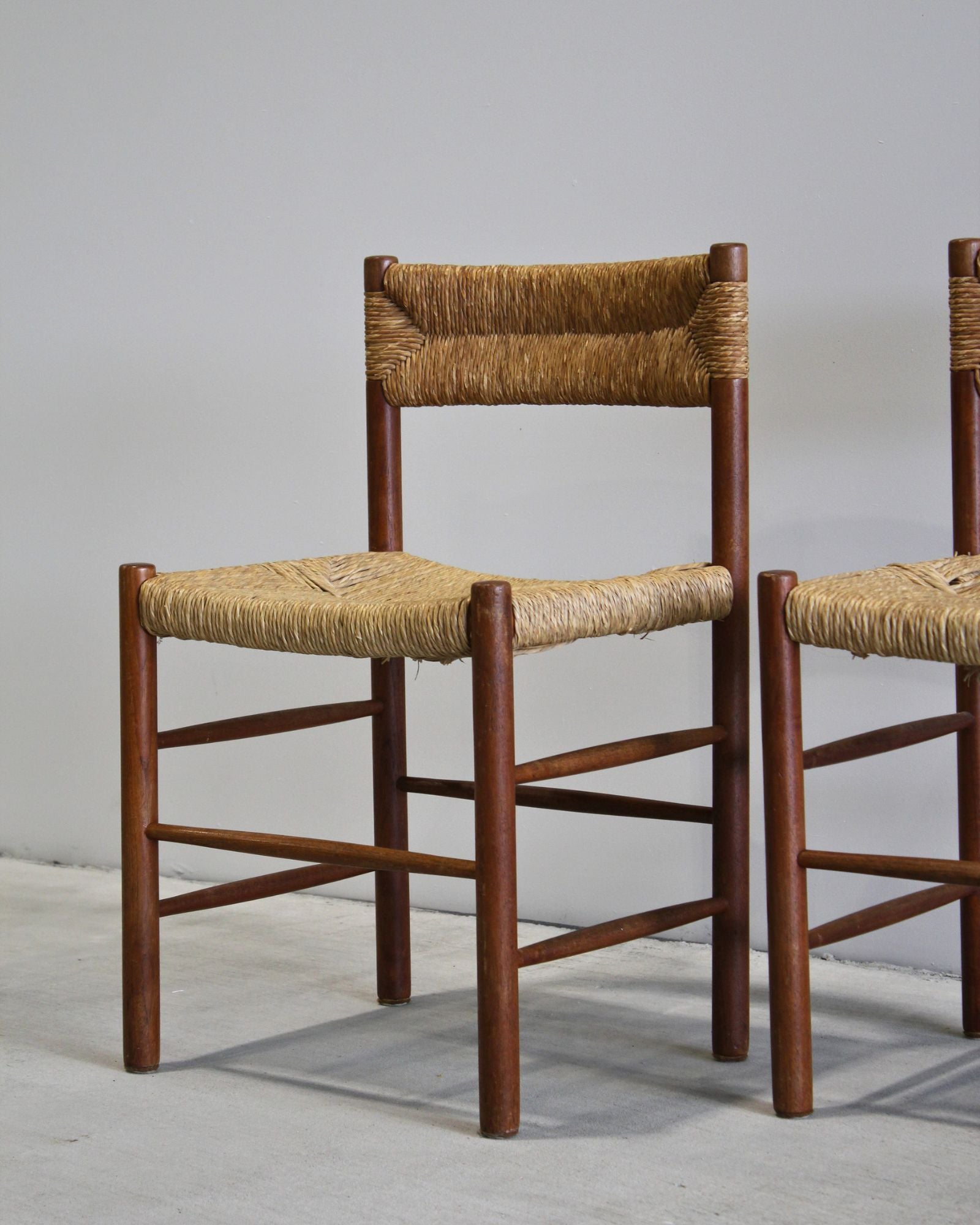 Pair of Dordogne dining chairs attributed to Charlotte Perriand, solid timber with woven rush seat and back, vintage French design, New Zealand