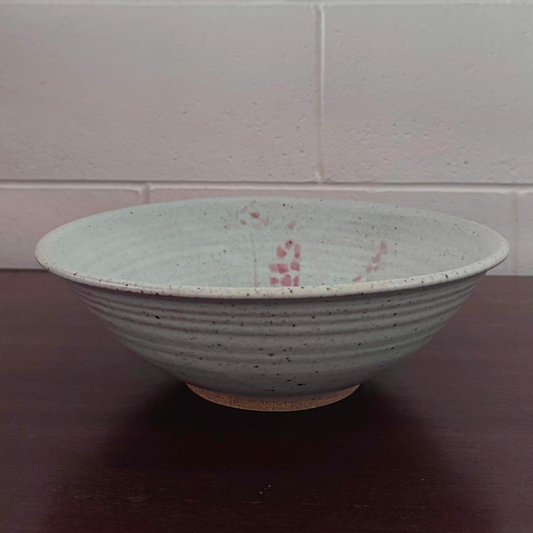 Grey ceramic bowl with speckled glaze and subtle pink accents