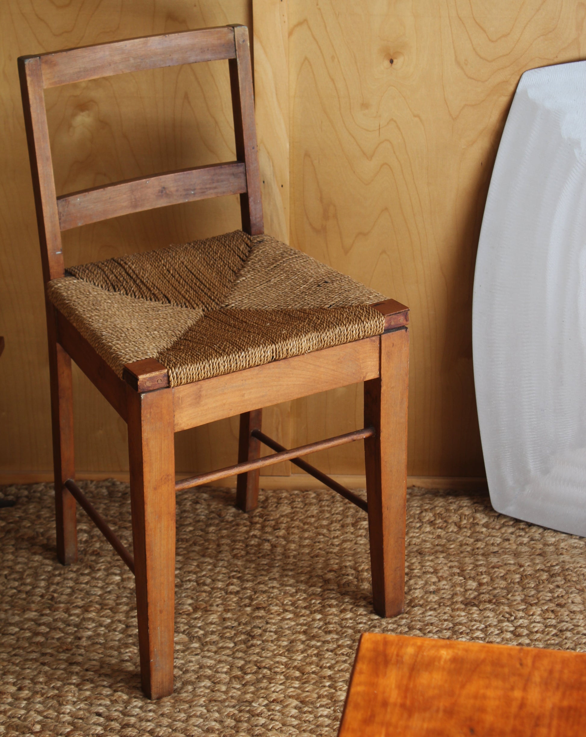 Wooden chair with woven seat on a wooden floor