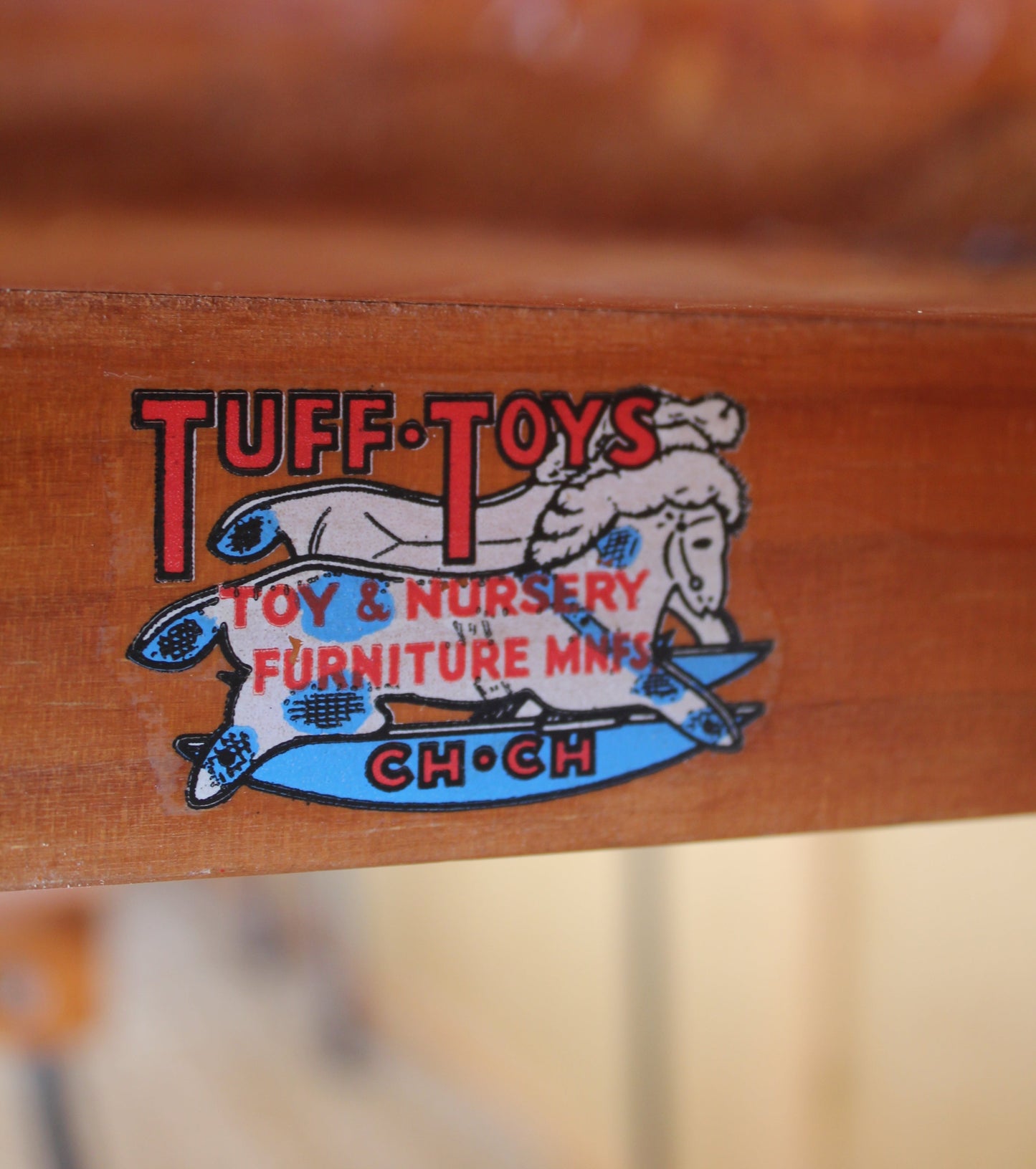 Wooden product with a 'Tuffy of Toys' logo on a blurred background