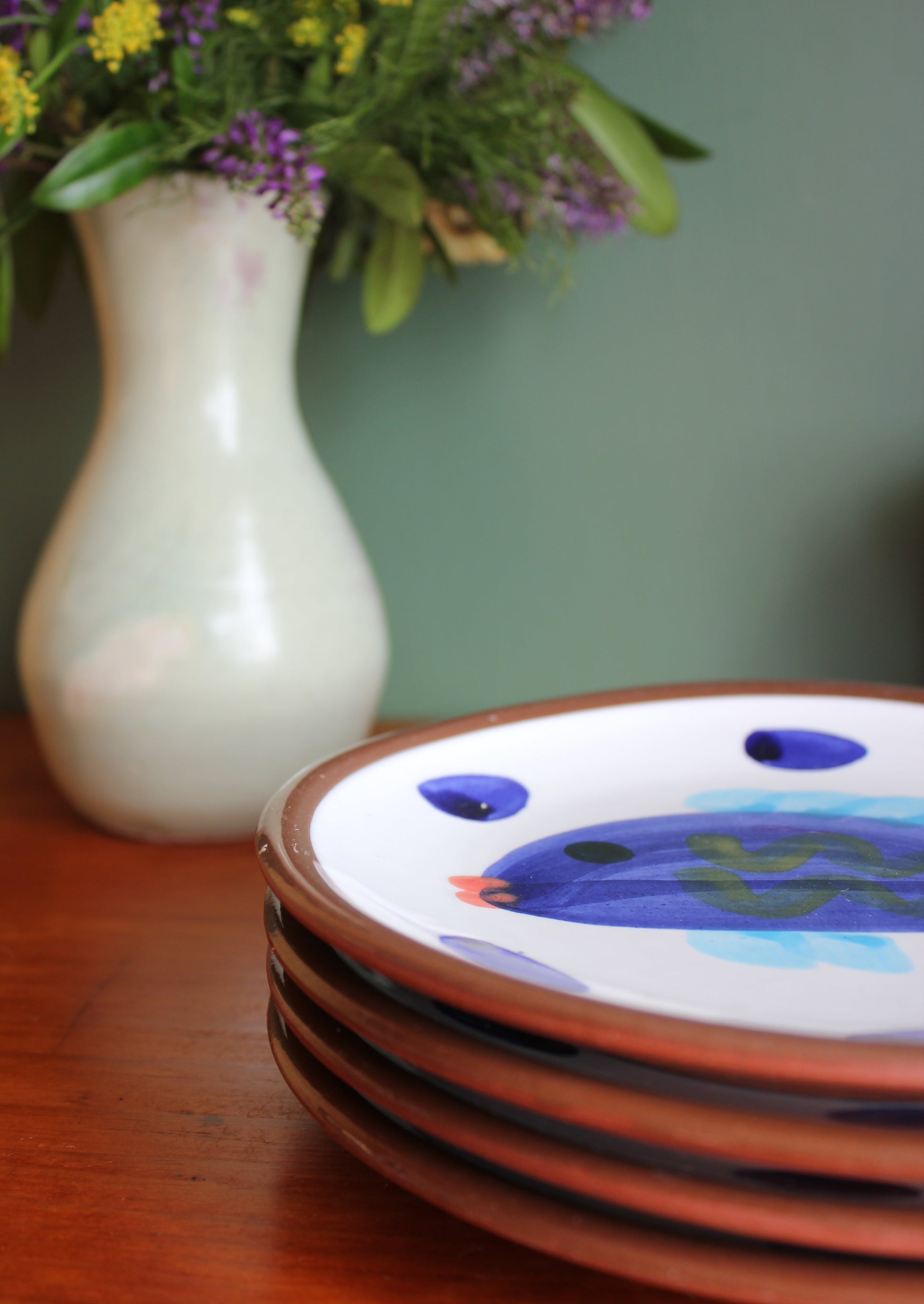 Decorative ceramic item with a floral arrangement on a wooden surface