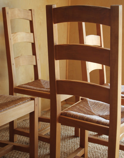 Wooden chair with woven seat on a wooden floor