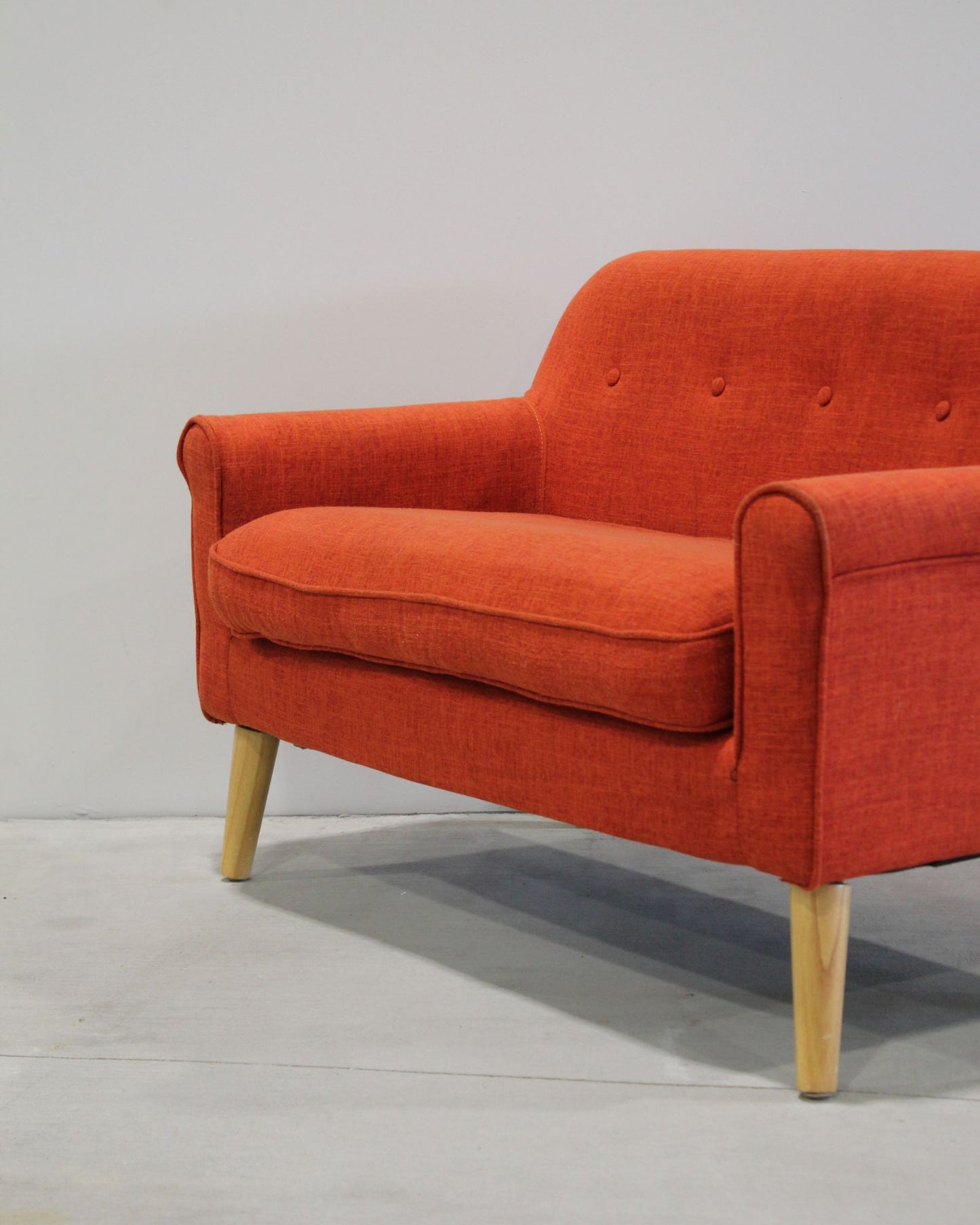 Mid-century inspired kids loveseat in orange, timber legs, compact two-seater, second hand children’s furniture New Zealand