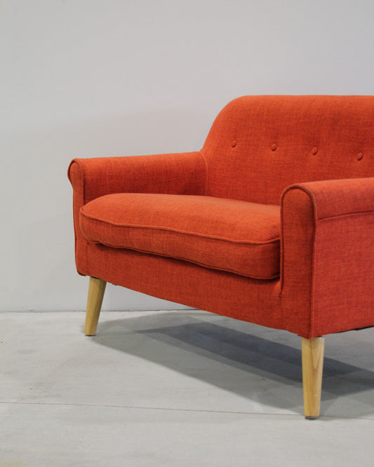 Mid-century inspired kids loveseat in orange, timber legs, compact two-seater, second hand children’s furniture New Zealand
