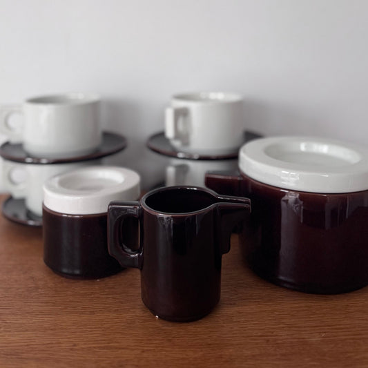 Vintage Italian Modernist ceramic tea and coffee set featuring deep brown glaze with white accents, including cups, saucers, teapot, creamer, and sugar jar.