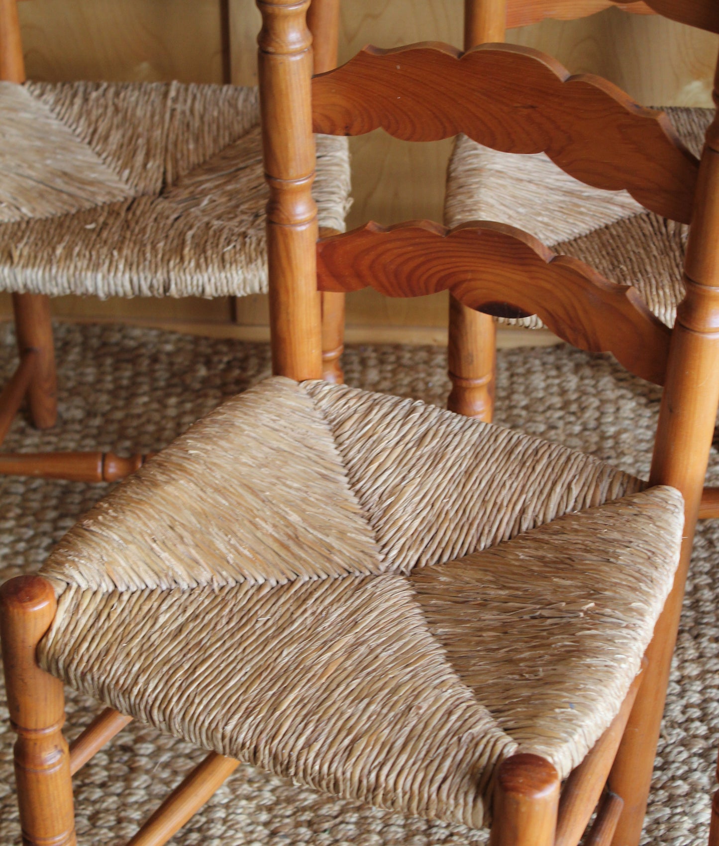 Close-up of a woven chair with a textured background